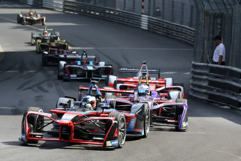Startfeld einer Formel-Rennserie in einer engen Kurve